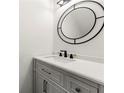 Bathroom featuring modern vanity, a designer mirror, and elegant finishes at 732 Jamestown Xing, Jonesboro, GA 30238