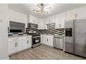 Modern kitchen featuring stainless steel appliances, stylish backsplash and new lighting at 732 Jamestown Xing, Jonesboro, GA 30238