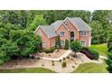 Elegant brick home boasts lush landscaping, a stone walkway, and decorative shrubbery at 805 Cog Hl, Mcdonough, GA 30253