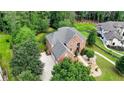 Beautiful brick home with an attached garage and lush landscaping, surrounded by mature trees at 805 Cog Hl, Mcdonough, GA 30253