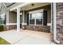 Close-up of a covered front porch featuring stone accents and white columns for curb appeal at 132 Berkleigh Trails Dr, Hiram, GA 30141
