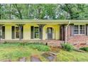 Inviting front porch features brick accents, decorative iron posts and stone pathway to the front door at 1970 Fisher Ne Trl, Atlanta, GA 30345