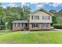 Charming two-story home with a well-maintained lawn and brick and siding exterior at 4444 Lisa Nw Way, Lilburn, GA 30047