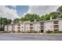 Well-maintained apartment building with manicured landscaping and charming architectural details at 591 Emory Oaks Way # 591, Decatur, GA 30033
