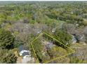 Aerial view of property surrounded by lush trees in a neighborhood with distant skyline at 2386 Bohler Nw Rd, Atlanta, GA 30327