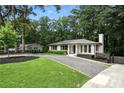 Beautiful single-story home featuring a manicured front lawn and a long driveway at 2676 Cottonwood Dr, Marietta, GA 30066