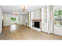 Sunlit living room boasting hardwood floors and a cozy fireplace at 2676 Cottonwood Dr, Marietta, GA 30066