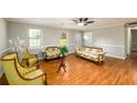 Bright living room with hardwood floors, neutral walls, and classic furniture arrangement at 3645 Shrewsbury Ct, Snellville, GA 30039
