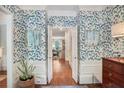 Elegant foyer with hardwood floors, stylish wallpaper, and a view into the adjacent living area at 377 Camden Ne Rd, Atlanta, GA 30309