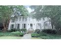 Charming two-story white brick home with mature trees and landscaping, offering great curb appeal at 377 Camden Ne Rd, Atlanta, GA 30309