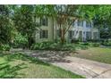 A lovely two-story home with great curb appeal, featuring a manicured lawn and a driveway gate at 377 Camden Ne Rd, Atlanta, GA 30309
