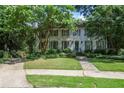 Beautiful two-story home with green shutters, mature trees, and a well-maintained lawn at 377 Camden Ne Rd, Atlanta, GA 30309