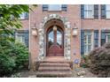 Elegant brick home featuring a covered entryway with stone archway at 1155 Admiral Xing, Alpharetta, GA 30005