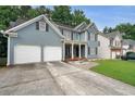Beautiful two-story home with a two-car garage, a covered front porch, and a concrete driveway at 4321 Clairesbrook Ln, Acworth, GA 30101