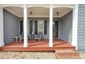 Inviting front porch with seating, decorative columns, and a welcoming entrance at 4321 Clairesbrook Ln, Acworth, GA 30101