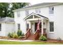Close-up of the front porch featuring wooden stairs, landscaping, and visible house numbers at 5070 Hensley Dr, Atlanta, GA 30338
