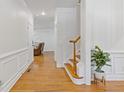 Inviting foyer with hardwood floors, wainscoting, and a staircase leading to the upper level of the home at 3541 Wilton Ave, Atlanta, GA 30340
