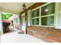 Inviting brick front porch with a welcome sign and large windows offering plenty of natural light at 514 Macedonia Forest Circle Cir, Canton, GA 30115