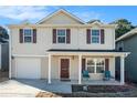 Inviting two-story home with a welcoming front porch, garage, and a well-maintained facade at 5987 Westchase St, Atlanta, GA 30336