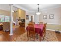 Formal dining area featuring hardwood floors, a decorative rug, and a six-chair dining set at 2905 Ivey Ridge Ln, Roswell, GA 30076