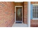 Elegant front door with a glass insert and a welcoming black mat, framed by brick walls at 2905 Ivey Ridge Ln, Roswell, GA 30076
