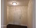 Inviting foyer with wood-look floors and a classic white front door with decorative ceiling at 303 Tara Commons Cir, Loganville, GA 30052