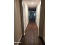 Hallway featuring wood floors connecting to a living space with natural light at 303 Tara Commons Cir, Loganville, GA 30052