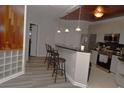 Kitchen has light colored cabinets, stainless steel appliances, and bar stool seating at 400 17Th Nw St # 2412, Atlanta, GA 30363