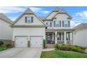 Charming two-story home with a welcoming front porch and a well-manicured front yard at 4110 Morgan Elizabeth Way, Cumming, GA 30041