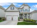 Charming two-story home with a welcoming front porch and a well-manicured front yard at 4110 Morgan Elizabeth Way, Cumming, GA 30041