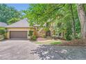 Beautiful home with a two-car garage, stone accents, and mature landscaping creating a welcoming curb appeal at 110 Boulder Dr, Roswell, GA 30075