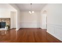 Elegant dining room boasting hardwood floors, wainscoting, and classic lighting at 1935 Cobblestone Ne Cir, Brookhaven, GA 30319