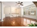 Spacious living room with hardwood floors, a ceiling fan and large bright window at 1935 Cobblestone Ne Cir, Brookhaven, GA 30319