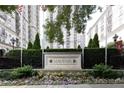 View of the Mayfair residence sign surrounded by beautiful plants and landscaping at 199 14Th Ne St # 412, Atlanta, GA 30309