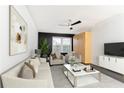 Bright living room with stylish decor, seating, and a modern ceiling fan at 199 14Th Ne St # 412, Atlanta, GA 30309