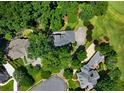 Aerial view of estate showing mature trees and neighborhood near a golf course at 2202 Lattimore Farm Nw Dr, Kennesaw, GA 30152