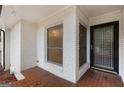 Covered entryway featuring tiled flooring, a modern door, and brick walls for a stylish welcome at 2544 Overlook Dr, Atlanta, GA 30344