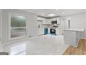 Bright kitchen with white cabinets, stainless steel appliances, and a marble-top breakfast bar at 2544 Overlook Dr, Atlanta, GA 30344