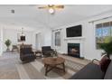 Cozy living room with a fireplace, large windows, and a view of the adjacent dining area at 2209 N Forest Trl, Atlanta, GA 30338