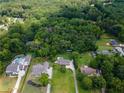 Expansive aerial view showcases the home's setting among lush greenery and nearby homes at 4017 S South Bogan Road Rd, Buford, GA 30519