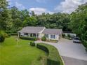 Charming home featuring a well-manicured lawn, fountain, and a welcoming covered porch at 4017 S South Bogan Road Rd, Buford, GA 30519