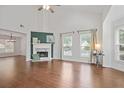 Bright living room featuring a fireplace, hardwood floors, high ceilings, and large windows at 2983 Albright Nw Commons, Kennesaw, GA 30144