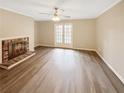 Bright living room features a fireplace, ceiling fan, hardwood floors, and double doors to the outside at 2992 Parc Lorraine, Lithonia, GA 30038