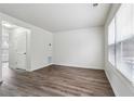 Bright living room with laminate flooring, large windows, and fresh white paint at 4282 Worth Nw St, Acworth, GA 30101