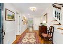 Long foyer with hardwood floors, a decorative rug, and a staircase at 1508 Brianwood Rd # 1508, Decatur, GA 30033
