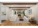 Bright living room with hardwood floors, fireplace, and exposed wood beams at 229 Devonwood Dr, Atlanta, GA 30328