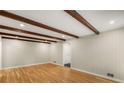 Large living room with hardwood floors, exposed beam ceiling, and neutral paint at 229 Devonwood Dr, Atlanta, GA 30328