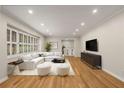 Bright living room with hardwood floors, plantation shutters, recessed lighting, and neutral decor offers a cozy and inviting space at 229 Devonwood Dr, Atlanta, GA 30328
