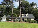 Charming single-story home with dormer windows, black shutters, and a well-manicured lawn at 229 Devonwood Drive Dr, Atlanta, GA 30328