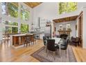 Bright and airy kitchen featuring a large island, stone fireplace, and expansive windows at 132 Lakeshore Dr, Roswell, GA 30075